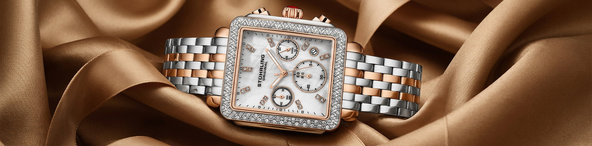 Luxury watch with diamond-studded face on a brown fabric background